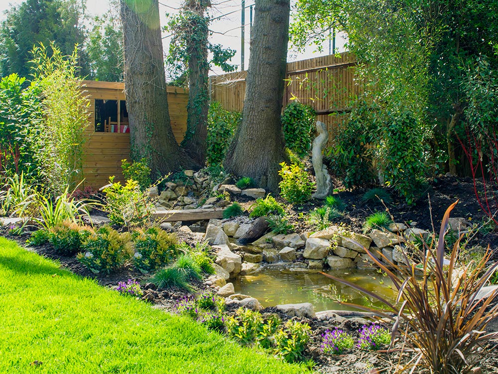 New water feature pond at garden rear